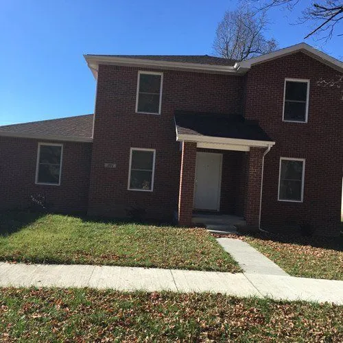 Two-story brick home with a covered entry